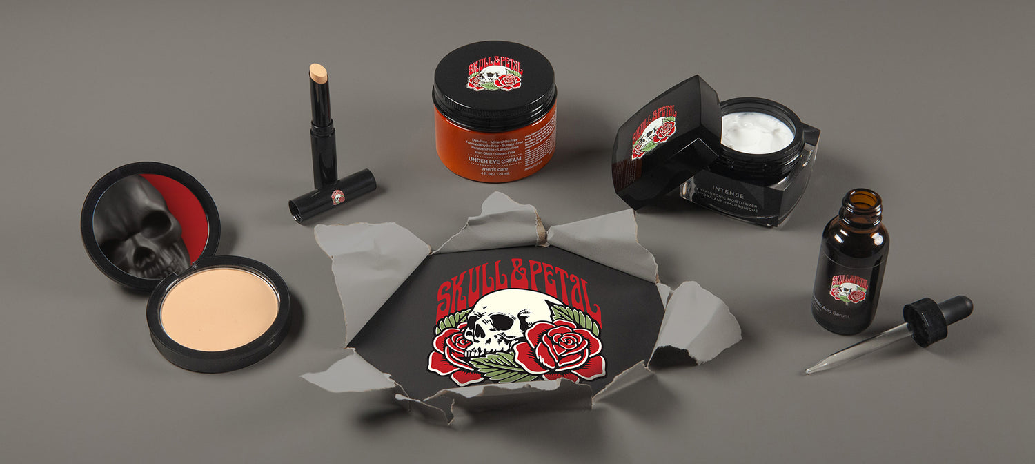 Skull & Petal products on a gray surface with the logo breaking through the surface