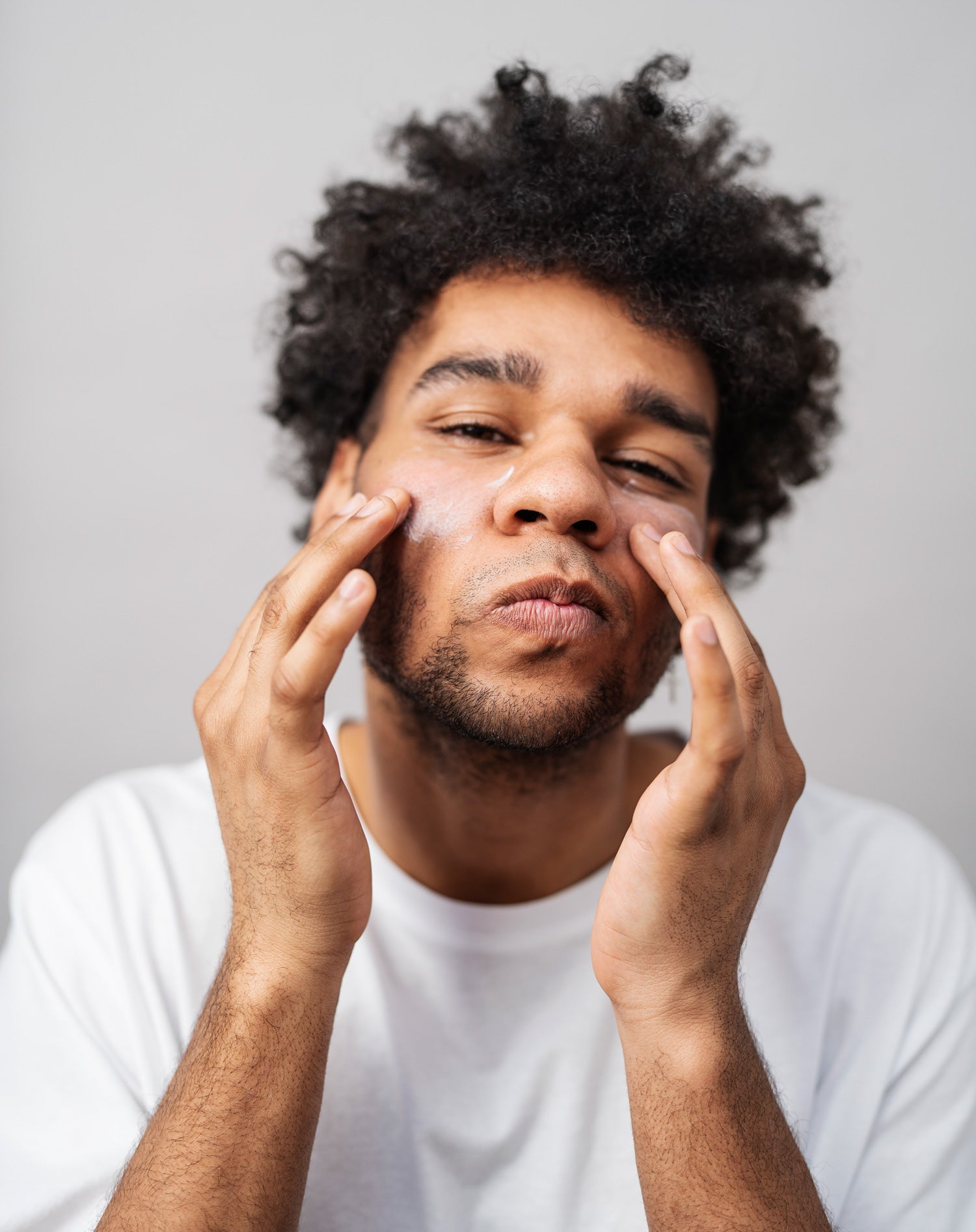 Man applying moisturizer to his face