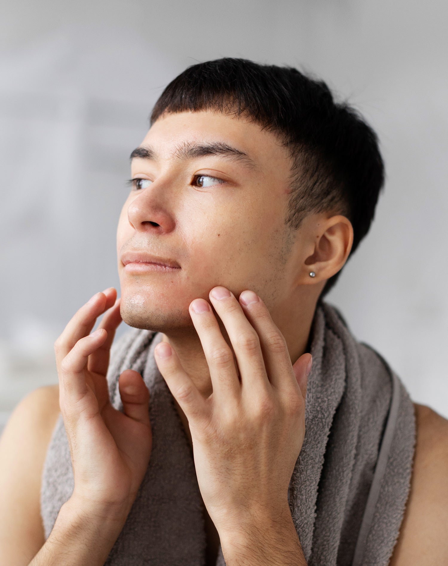 Man looking to the side after washing his face