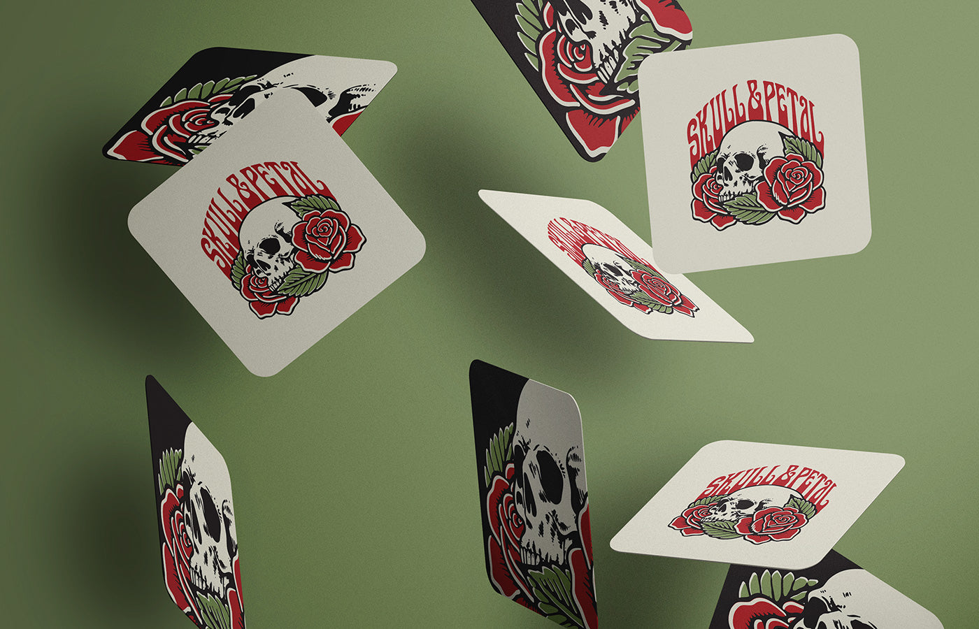 Multiple cards with Skull & Petal logo on them falling in mid-air